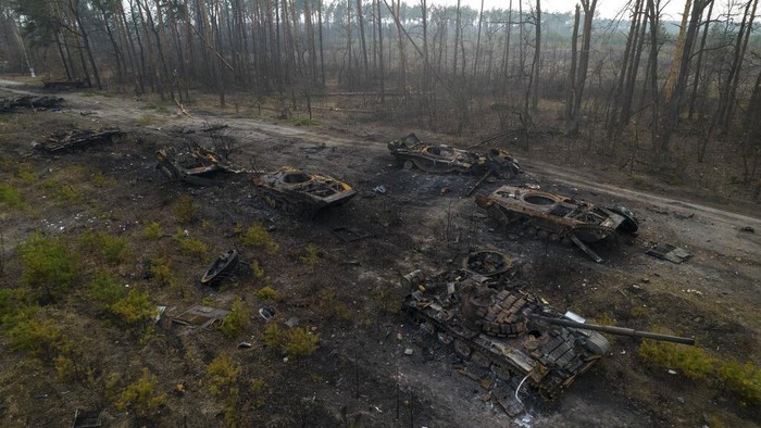 Ukrainian soldiers pass on top of an armored vehicle next to destroyed Russian tanks in the outskirts of Kyiv, Ukraine, Thursday, March 31, 2022. Russian forces shelled Kyiv suburbs, two days after the Kremlin announced it would significantly scale back operations near both the capital and the northern city of Chernihiv to “increase mutual trust and create conditions for further negotiations.” (AP Photo/Rodrigo Abd)
