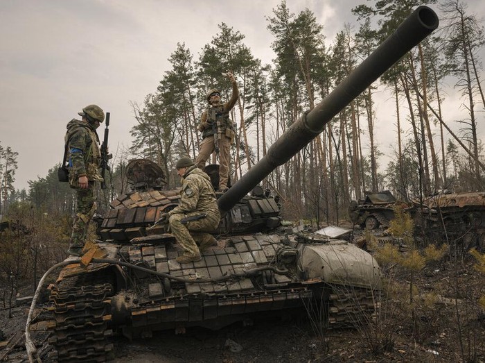 Ukrainian soldiers pass on top of an armored vehicle next to destroyed Russian tanks in the outskirts of Kyiv, Ukraine, Thursday, March 31, 2022. Russian forces shelled Kyiv suburbs, two days after the Kremlin announced it would significantly scale back operations near both the capital and the northern city of Chernihiv to “increase mutual trust and create conditions for further negotiations.” (AP Photo/Rodrigo Abd)