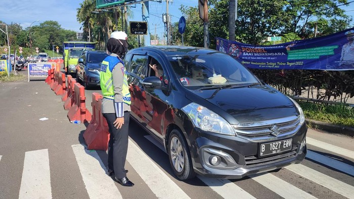 Polisi melakukan pemeriksaan kendaraan di jalur Puncak