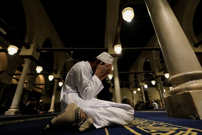 A Muslim worshipper cries after evening prayers called 