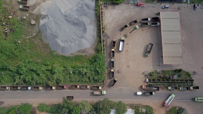 Foto udara sejumlah truk antre untuk mengisi bahan bakar solar bersubsidi di SPBU Jalan Lingkar Selatan, Jambi, Sabtu (2/4/2022). Direktur Utama Pertamina Nicke Widyawati mengatakan sesuai undang-undang mobil truk batu bara tidak diperbolehkan mengisi Bahan Bakar Minyak (BBM) solar bersubsidi yang ada di seluruh SPBU karena truk pengangkut batu bara merupakan industri besar yang tidak menerima subsidi solar dari pemerintah. ANTARA FOTO/Wahdi Septiawan/tom.