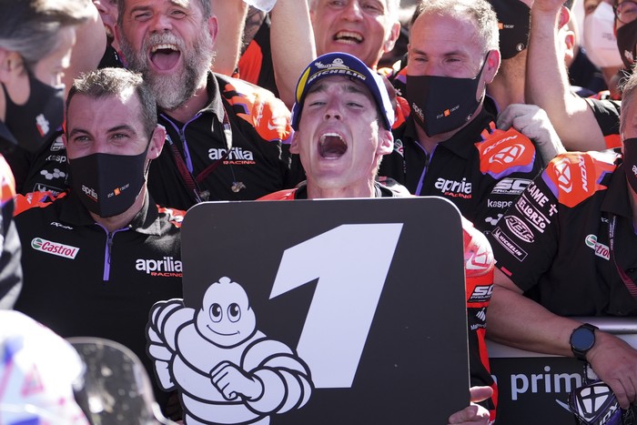 Spanish rider Aleix Espargaro of Aprilia Racing, center, celebrates winning the MotoGP race at the circuit in Termas de Rio Hondo, Argentina, Sunday, April 3, 2022. (AP Photo/Nicolas Aguilera)