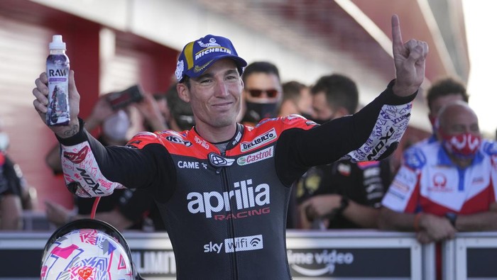 Spanish rider Aleix Espargaro of Aprilia Racing team celebrates first place in the qualifying race of MotoGP at the circuit in Termas de Rio Hondo, Argentina, Saturday, April 2, 2022. (AP Photo/Nicolas Aguilera)