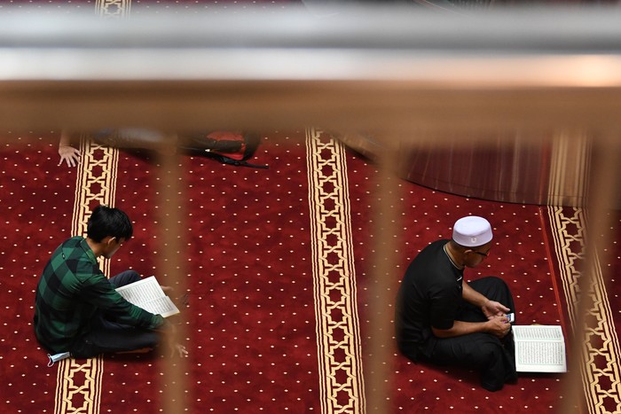 Umat Islam membaca Al Quran di kompleks Masjid Istiqlal, Jakarta, Minggu (3/4/2022). Membaca Al Quran (tadarus)  dilakukan umat Islam untuk meningkatkan ibadah selama bulan suci Ramadhan. ANTARA FOTO/Aditya Pradana Putra/YU