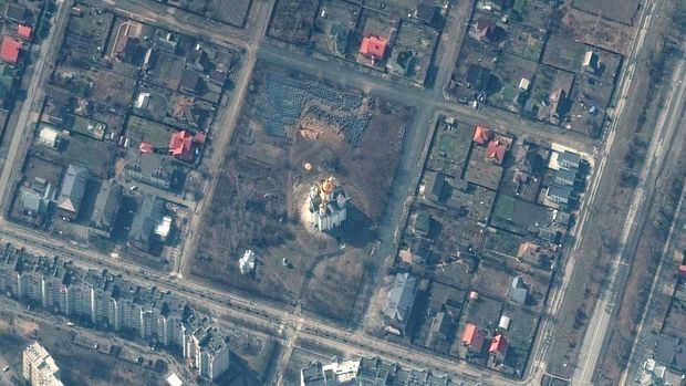 A satellite image shows the grave site with an approximately 45-foot (approximately 13,7 meters) long trench in the southwestern section of the area near the Church of St. Andrew and Pyervozvannoho All Saints, in Bucha, Ukraine, March 31, 2022. Picture taken March 31, 2022. Satellite image 2022 Maxar Technologies/Handout via REUTERS