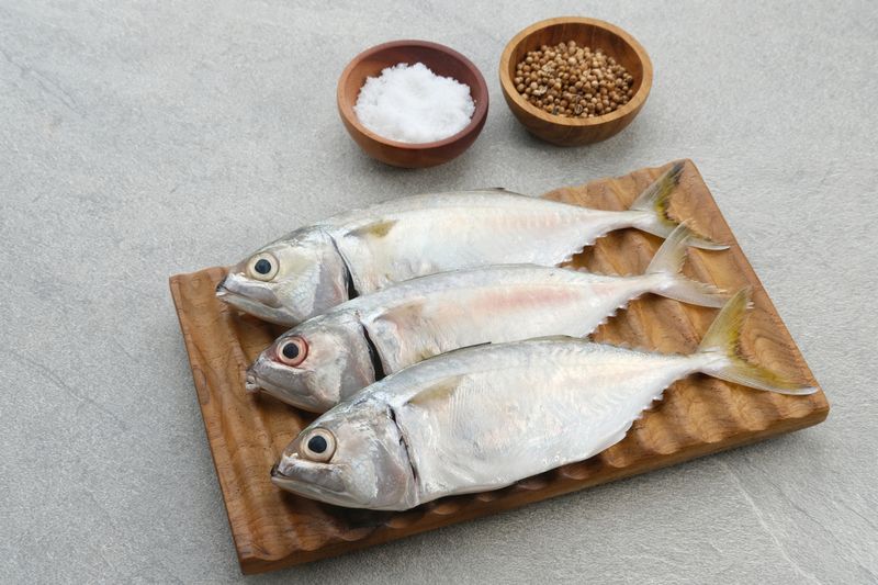 Ikan Kembung, Kembung Fish or Mackerel Fish on wooden chopping board.