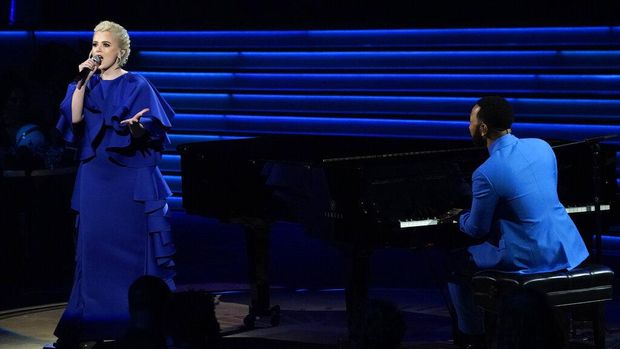 Ukrainian singer Mika Newton, left, and John Legend perform 
