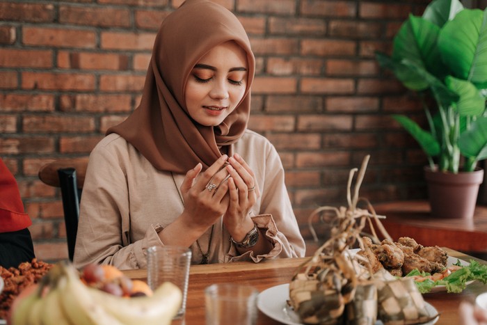 close up gesture of hand pick some food in dining table during dinner