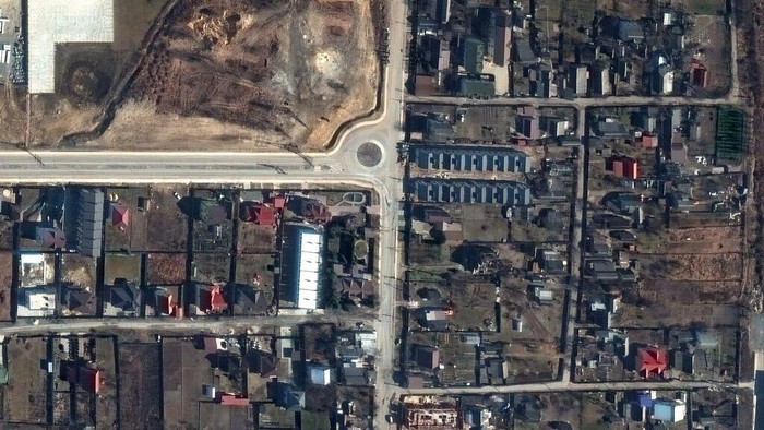 This handout satellite image released by Maxar Technologies shows a view of Yablonska Street in Bucha, Ukraine, on March 19, 2022, when bodies of civilians were on the street and found by Ukrainian officials weeks later when Russian forces withdrew - Satellite image ©2022 Maxar Technologies/AFP