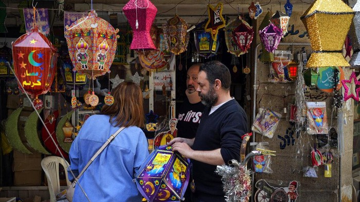 People shop decorations for the Muslim holy month of Ramadan at a shop in Beirut, Lebanon, Saturday, April 2, 2022. Muslims throughout the world are marking the Ramadan, a month of fasting during which observants abstain from food, drink and other pleasures from sunrise to sunset. (AP Photo/Bilal Hussein)