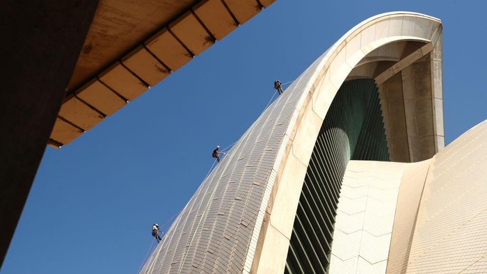 SYDNEY, AUSTRALIA - APRIL 05: Building Operations staff inspect tiles on the Sydney Opera House sails on April 05, 2022 in Sydney, Australia. The 'tile tapping' test is conducted every five years to inspect the health of the tiles that cover the Sydney Opera Houses' iconic sails and takes six weeks to complete. A specific type of hammer is used to lightly tap the tiles with each tile emitting a particular type of sound which indicates whether it is due for repair or still in good condition. There is a limited supply of backup tiles in stock for replacement, so the tile tapping check is an essential maintenance activity for the building. (Photo by Mark Metcalfe/Getty Images)