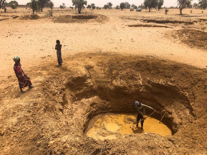 A man digs a pit to obtain water, in a dry river bed, near the village of Tata Bathily in Matam, Senegal March 30, 2022. Picture taken March 30, 2022. REUTERS/Edward McAllister     TPX IMAGES OF THE DAY