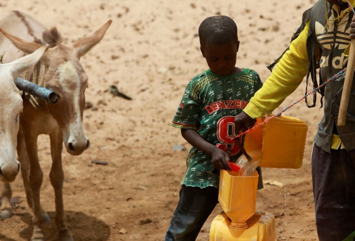 A man digs a pit to get water, in a dry river bed, near the village of Tata Bathily in Matam, Senegal March 30, 2022. Picture taken March 30, 2022. REUTERS/Ngouda Dione