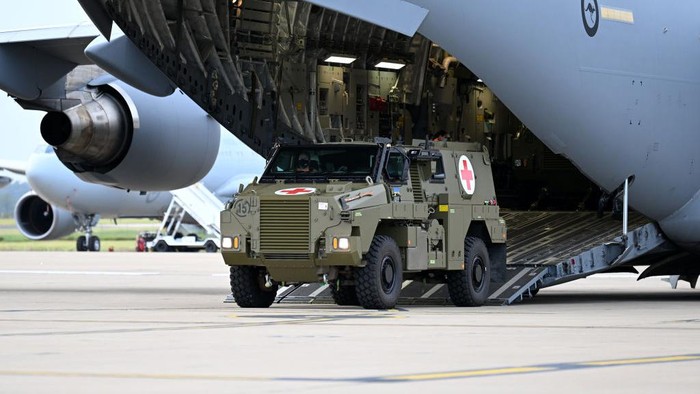 IPSWICH, AUSTRALIA - APRIL 08: An Australian Bushmaster PMV Armoured Vehicle is loaded onto a RAAF C-17 cargo plane at the Amberley Air Base on April 08, 2022 in Ipswich, Australia. The Australian government is sending a total of 20 Bushmaster Protected Mobility Vehicles to Ukraine following a direct request for assistance by Ukrainian President Volodymyr Zelenskyy during his virtual address to the Australian parliament last Thursday. (Photo by Dan Peled/Getty Images)