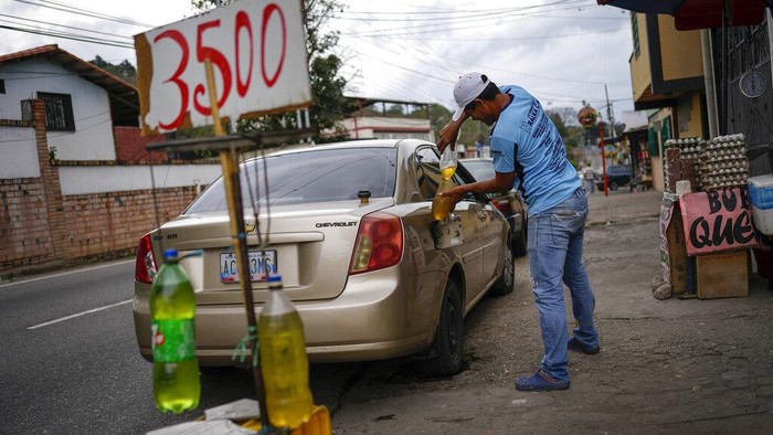 BBM Langka di Venezuela, Harga Eceran Melambung Tinggi Plastic bottles with gasoline are displayed for sale with a price in Colombian currency, in San Cristobal, Venezuela, Thursday, April 7, 2022. Amid the fuel shortage outside of Venezuela's capital, drivers are only allowed to buy 40 liters of gasoline a week, and black marketeers along the Venezuelan-Colombian border sell it only in Colombian currency or US Dollars, for twice its original price. (AP Photo/Matias Delacroix)