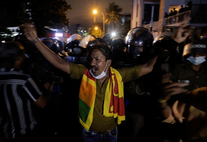 Police officers try to hold the metal barrier gates as demonstrators pull it off during a protest near Temple Trees Prime Minister Mahinda Rajapaksas official residence, amid the countrys economic crisis in Colombo, Sri Lanka, April 7, 2022. REUTERS/Dinuka Liyanawatte
