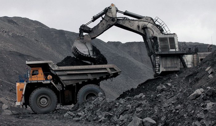 A machine loads a BelAZ dump-body truck with coal at the Chernigovsky opencast colliery, outside the town of Beryozovsky, Kemerovo region, Siberia, Russia, April 4, 2016. REUTERS/Ilya Naymushin/File Photo