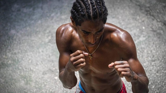 A boxer known as Jonathan trains at the Rafael Trejo boxing gym in Old Havana, Cuba, Wednesday, April 6, 2022. Cuba banned professional boxing shortly after the 1959 revolution, but boxers will be allowed to fight professionally in Cuba again for the first time under a deal with a Mexican promoter, officials announced March 4, 2022. (AP Photo/Ramon Espinosa)