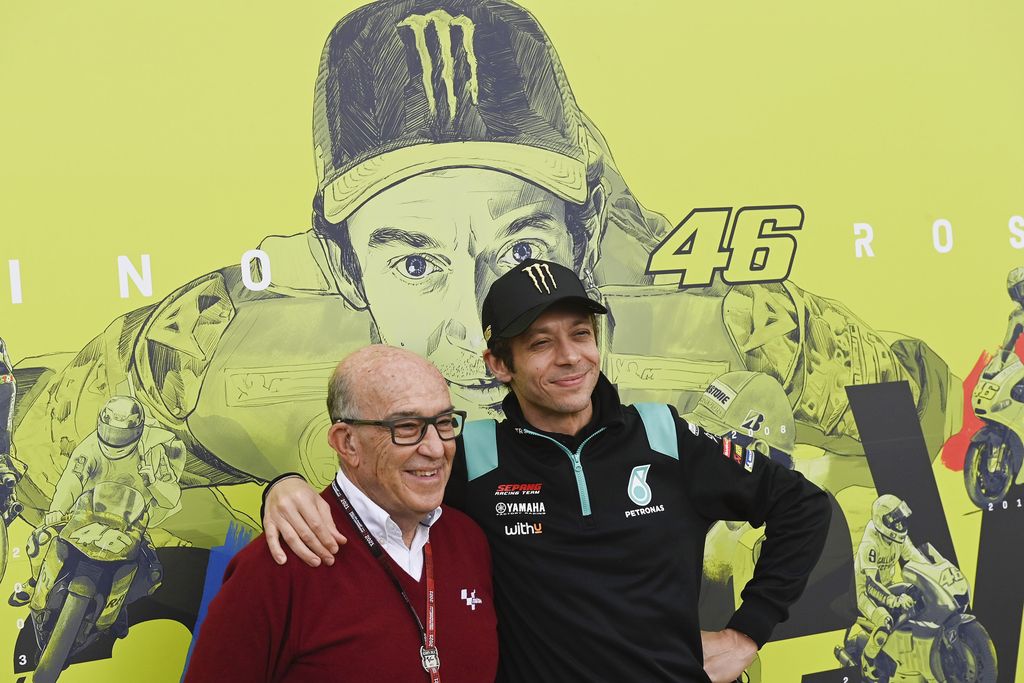VALENCIA, SPAIN - NOVEMBER 11: Carmelo Ezpeleta (L) of Spain and Dorna CEO and Valentino Rossi of Italy and Petronas Yamaha SRT pose near the murals in paddock during the MotoGP of Comunitat Valenciana: Previews at Ricardo Tormo Circuit on November 11, 2021 in Valencia, Spain. (Photo by Mirco Lazzari gp/Getty Images)