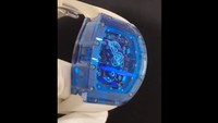 Bentuk bingkai atau bezel jam ini kotak cenderung oval dengan warna dominan biru terang cenderung transparan. Ada 12 sekrup warna perak di bingkainya. Muka piringan jam ini transparan sehingga jarum jam berwarna perak terlihat seolah bersatu dengan mesin di belakangnya dan seperti mengambang di air biru. (Dok Tony Sutrisno)