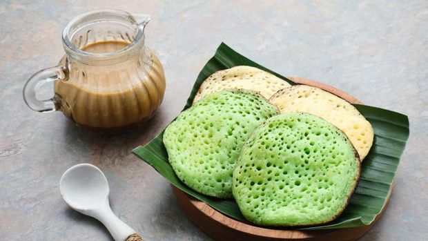 Serabi or Surabi, Indonesian pancake made of flour, rice flour and coconut milk. Served with palm sugar sauce. Sweet and savory.