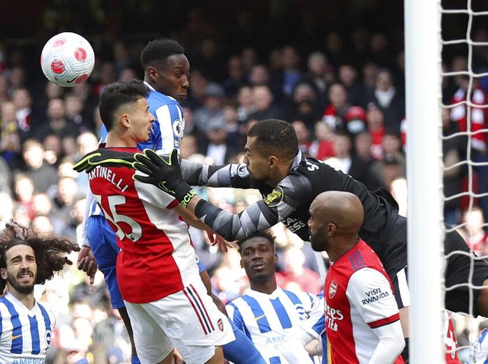 Brighton's goalkeeper Robert Sanchez makes a save in front of Arsenal's Gabriel Martinelli, center left, during the English Premier League soccer match between Arsenal and Brighton and Hove Albion at Emirates stadium in London, Saturday, April 9, 2022. (AP Photo/Ian Walton)
