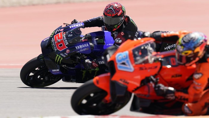 Fabio Quartararo (20), of France, passes Remy Gardner (87), of Australia, on a turn during an open practice session for the MotoGP Grand Prix of the Americas motorcycle race at the Circuit of the Americas, Saturday, April 9, 2022, in Austin, Texas. (AP Photo/Eric Gay)