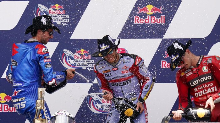 Enea Bastianini, center, of Italy, celebrates after winning the MotoGP Grand Prix of the Americas motorcycle race at the Circuit of the Americas, Sunday, April 10, 2022, in Austin, Texas. Alex Rins, left, of Spain, finished second, and Jack Miller, right, of Australia, finished third. (AP Photo/Eric Gay)