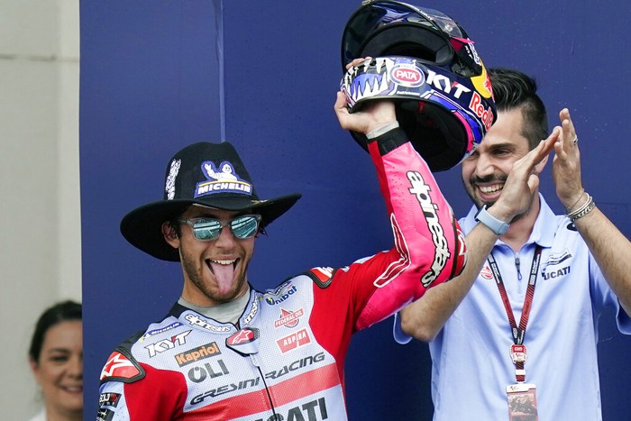 Enea Bastianini, center, of Italy, celebrates after winning the MotoGP Grand Prix of the Americas motorcycle race at the Circuit of the Americas, Sunday, April 10, 2022, in Austin, Texas. Alex Rins, left, of Spain, finished second, and Jack Miller, right, of Australia, finished third. (AP Photo/Eric Gay)