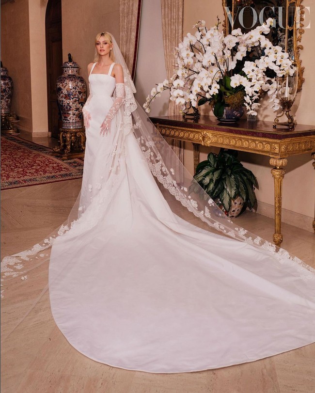Nicola Peltz tampil cantik dan megah dalam balutan busana pengantin keluaran Maison Valentino. Gaun dengan train panjang itu tampak lebih dramatis dengan veil berhias bordir yang menyapu lantai. Foto: Dok. Vogue British