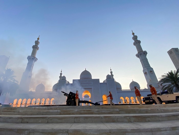 RELIGION-RAMADAN/EMIRATES A policeman is pictured as a military cannon is fired to mark sunset and the end of the fasting day, during the holy month of Ramadan at the Sheikh Zayed Grand Mosque in Abu Dhabi, United Arab Emirates, April 9, 2022. Picture taken April 9, 2022. REUTERS/Abdel Hadi Ramahi