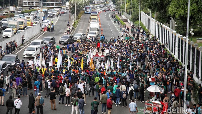 Pantauan detikcom di Gedung DPR RI, Jakarta Pusat, Senin (11/4/2022), massa aksi mulai merapat ke pintu utama Gedung DPR RI. Perwakilan dari mereka memanjat pagar hitam yang di DPR.