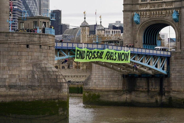 Britain Climate Protest Activists from Extinction Rebellion take part in a climate change demonstration, demanding an immediate end to all new fossil fuel investments, on Oxford Street, central London, Saturday April 9, 2022. (Stefan Rousseau/PA via AP)