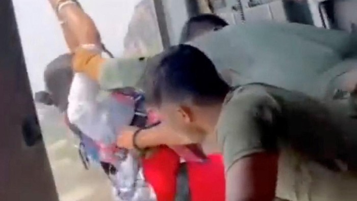 A person is pulled by Indian air force personnel to a helicopter during a rescue operation after a mid-air collision of two cable cars on Sunday trapped nearly 50 people in a dozen cars, in Deoghar district, Jharkhand state, India in this still image taken from a handout video obtained April 12, 2022. Courtesy Indian Air Force/Handout via REUTERS  THIS IMAGE HAS BEEN SUPPLIED BY A THIRD PARTY.  MANDATORY CREDIT