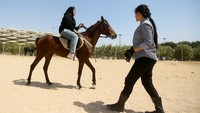 Fatima terlihat mengawasi Banin Falah (21) seorang wanita Irak yang sedang mendamami pelatihan berkuda.