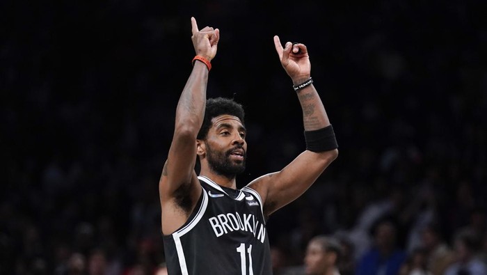 Brooklyn Nets Kyrie Irving reacts after sinking a basket during the second half of the opening basketball game of the NBA play-in tournament against the Cleveland Cavaliers, Tuesday, April 12, 2022, in New York. (AP Photo/Seth Wenig)