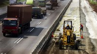 Pekerja mengoperasikan alat berat saat menyelesaikan proyek pelebaran jalan tol Jakarta-Cikampek di Karawang, Jawa Barat, Rabu (13/4/2022).