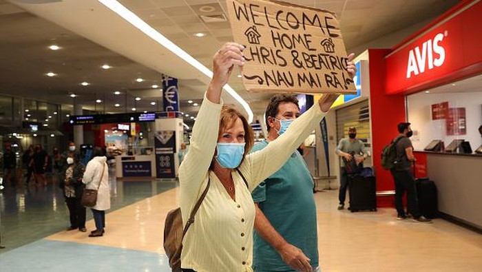 AUCKLAND, NEW ZEALAND - APRIL 13: Bette-May Waine (C) welcomes her grand daughter Mackenzie Waine (R) and daughter-in-law Lisa Waine (L) and family from Australia for a holiday to Auckland International Airport on April 13, 2022 in Auckland, New Zealand. New Zealand borders reopened to Australian tourists from 11:59 pm on Tuesday 12 April. Vaccinated Australian citizens and permanent residents are eligible for quarantine-free travel with a negative COVID-19 test prior to departure, with tests also taken upon arrival and again on day six in New Zealand. Travellers from countries with visa waiver arrangements such as the United Kingdom will be allowed to come to New Zealand from May 1. (Photo by Fiona Goodall/Getty Images)