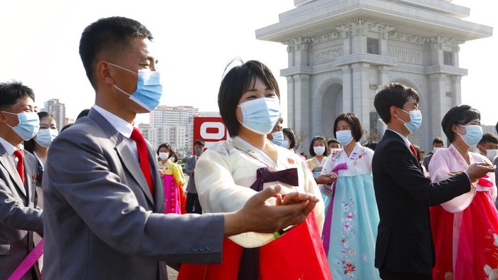 Students and youth of Pyongyang participate in a dancing party to commemorate the 10th anniversary of Kim Jong Uns election as the top party and state leader at the plaza of Arch of Triumph in Pyongyang, North Korea Monday, April 11, 2022. (AP Photo/Jon Chol Jin)