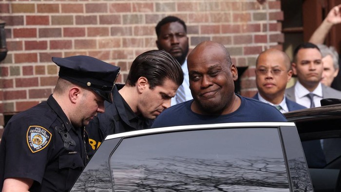 Frank James, the suspect in the Brooklyn subway shooting, reacts as he is escorted to a vehicle after leaving an NYPD precinct in Manhattan, New York City, U.S., April 13, 2022. REUTERS/Stephen Yang