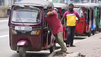 Para pengemudi kendaraan roda tiga atau bajaj rela antre panjang dan mendorong kendaraan mereka untuk mendapatkan bahan bakar.