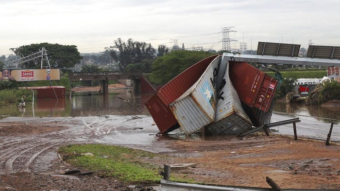 Children walk on damaged road at an informal settlement in Durban, South Africa, Thursday, April 14, 2022. Heavy rains and flooding have killed at least 341 people in South Africas eastern KwaZulu-Natal province, including the city of Durban, and more rainstorms are forecast in the coming days. (AP Photo/Str)