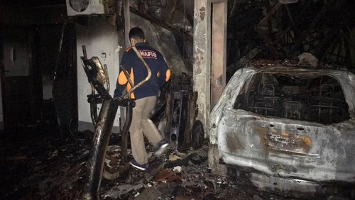 Petugas saat melakukan olah TKP kebakaran yang menghanguskan satu unit mobil dan rumah di Jalan Ratna, Gang Tunjung Nomor 17,  Banjar Tatasan, Tonja, Denpasar Utara, Jumat (15/4).