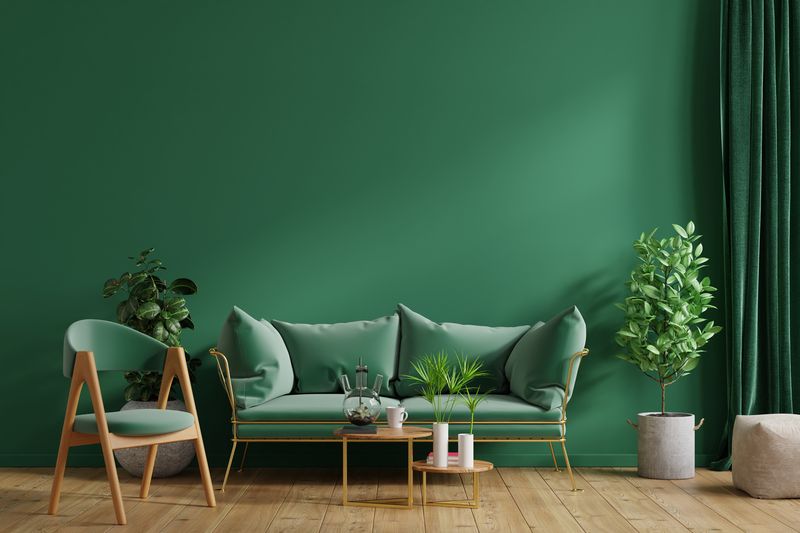 Interior mockup green wall with green sofa and green armchair in living room,3D rendering