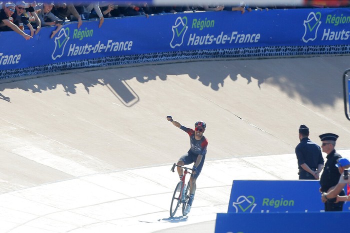 France Cycling Paris Roubaix Race winner, Netherland's Dylan Van Baarle, center, Wout van Aert of Belgium, left, second and Stefan Kung of Switzerland, third, pose on the podium after the Paris-Roubaix cycling race, a 257 kilometer (160 mile) one-day-race at the velodrome in Roubaix, northern France, Sunday, April 17, 2022. (AP Photo/Michel Spingler)