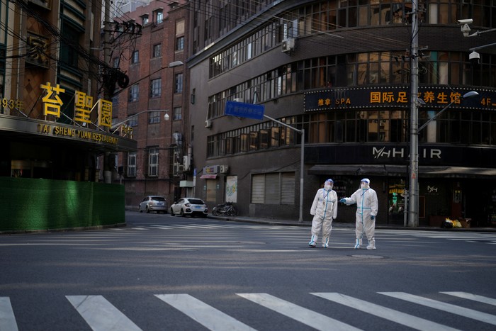 Residents stand on a street waiting for nucleic acid test during lockdown amid the coronavirus disease (COVID-19) pandemic, in Shanghai, China, April 17, 2022. REUTERS/Aly Song