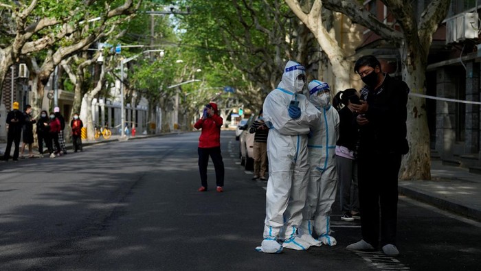 Residents stand on a street waiting for nucleic acid test during lockdown amid the coronavirus disease (COVID-19) pandemic, in Shanghai, China, April 17, 2022. REUTERS/Aly Song