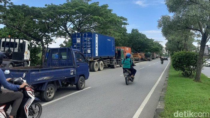 Puluhan kendaraan truk tengah antre di bahu jalan di kawasan SPBU Teratai Kendari.