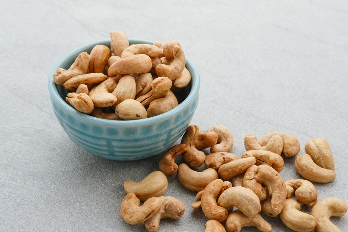 Cashew Nut, in Indonesia known as Kacang Mete. Served on grey background.