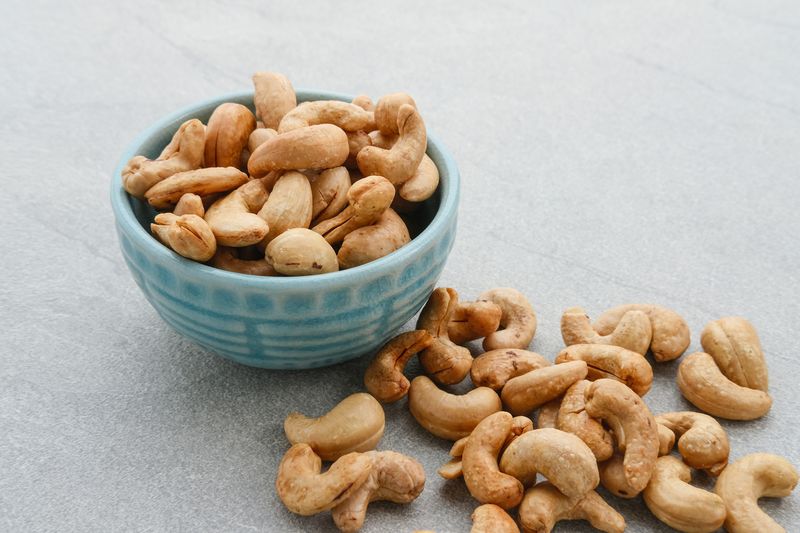 Cashew Nut, in Indonesia known as Kacang Mete. Served on grey background.